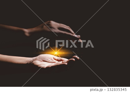 Hands holding glowing light, symbolizing hope, healing, faith, inspiration, spiritual energy, new beginning, miracle, inner strength and positive transformation from darkness to light. Hands holding glowing light, symbolizing hope, healing, faith, inspiration, spiritual energy, new beginning, miracle, inner strength and positive transformation from darkness to light. 132835345