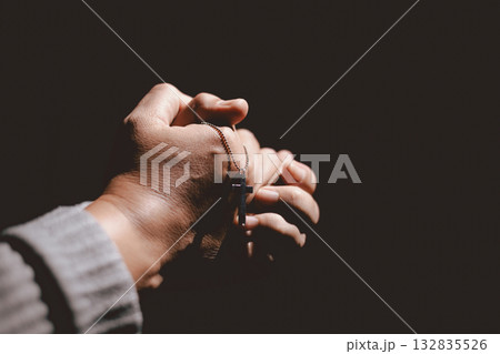 Person clasping hands in prayer, symbolizing faith, hope, spirituality, devotion, inner strength, meditation, belief, healing and the power of trust during difficult times in life. 132835526