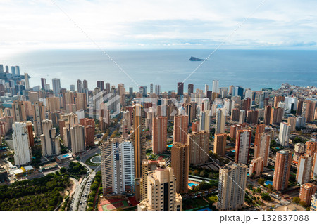 Scenic panorama capturing Benidorm tall buildings overlooking the blue waters of the Mediterranean Sea. Popular resort city on Costa Blanca with vibrant urban life and coastal beauty. Scenic panorama capturing Benidorm tall buildings overlooking the blue waters of the Mediterranean Sea. Popular resort city on Costa Blanca with vibrant urban life and coastal beauty. 132837088