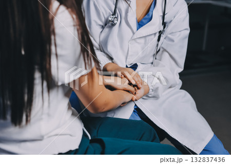 Doctor giving hope. Close up shot of young female physician leaning forward to smiling elderly lady patient holding her hand in palms. Woman caretaker in white coat supporting encouraging old person Doctor giving hope. Close up shot of young female physician leaning forward to smiling elderly lady patient holding her hand in palms. Woman caretaker in white coat supporting encouraging old person 132837436