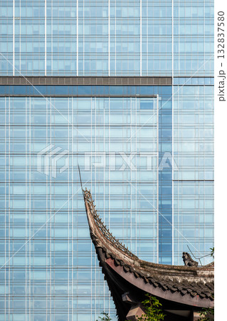 Modern architecture contrasts with traditional temple 132837580