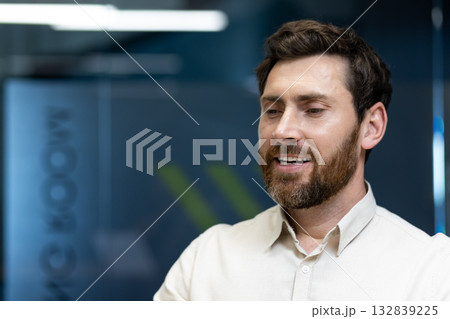 A close-up photo of a young man sitting at his workplace, eyes closed, resting and dreaming. A close-up photo of a young man sitting at his workplace, eyes closed, resting and dreaming. 132839225