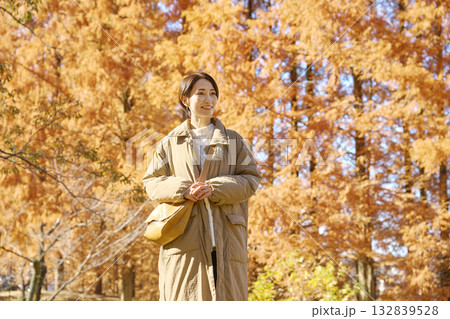 紅葉の中を散歩する女性 ミドルエイジ 紅葉の中を散歩する女性 ミドルエイジ 132839528