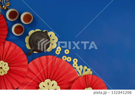 Chinese New Year Celebration. Festive decorations with tea set and red fans on blue background. 132841206