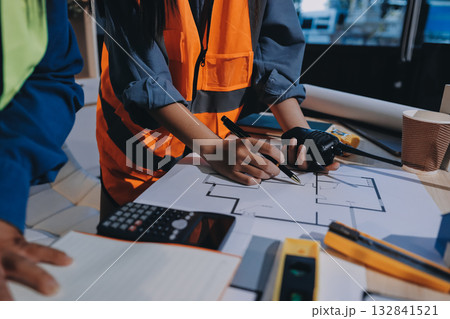 Architects and engineers working collaboratively on construction project 132841521