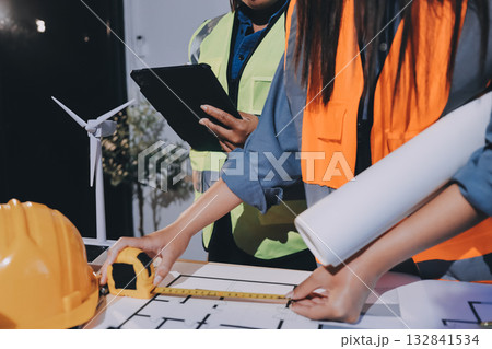 Architects and engineers working collaboratively on construction project Architects and engineers working collaboratively on construction project 132841534