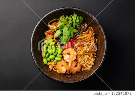 Delicious shrimp noodles served with fresh vegetables and herbs 132841872