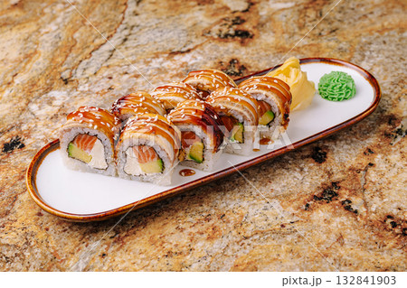 Delicious sushi platter served on a stylish plate in a cozy restaurant setting 132841903