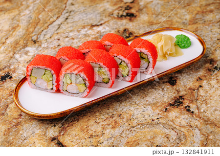 Bright sushi rolls served on a white plate with ginger and wasabi Bright sushi rolls served on a white plate with ginger and wasabi 132841911