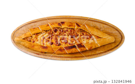 Delicious traditional homemade pide served on wooden board with perfect slices 132841946