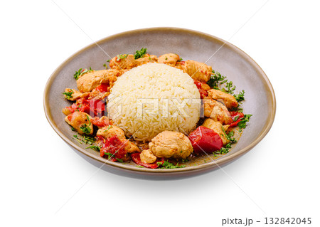 Delicious chicken and rice dish served on a round plate with fresh herbs 132842045