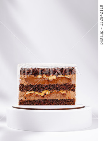 Delicious chocolate cake with layers of cream and fruit on display Delicious chocolate cake with layers of cream and fruit on display 132842119