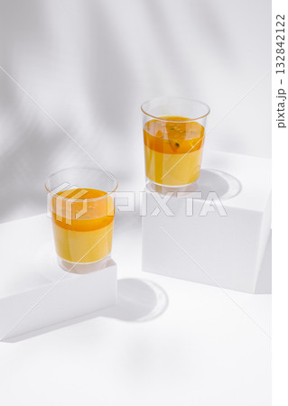 Bright tropical dessert glasses filled with creamy mango mousse and vibrant passion fruit sauce Bright tropical dessert glasses filled with creamy mango mousse and vibrant passion fruit sauce 132842122