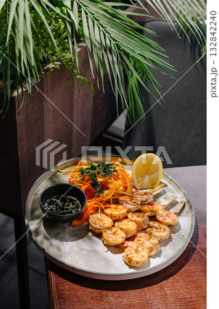 Fresh shrimp meal with vegetables and lemon in a restaurant setting Fresh shrimp meal with vegetables and lemon in a restaurant setting 132842240