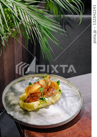 Gourmet dish served on elegant plate with fresh herbs and greens Gourmet dish served on elegant plate with fresh herbs and greens 132842241
