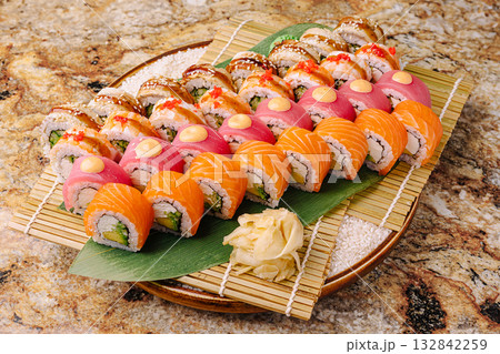 Delicious sushi platter showcasing vibrant rolls and garnishes 132842259