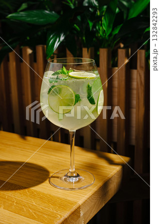 Refreshing cocktail with lime and mint served in a stylish glass 132842293