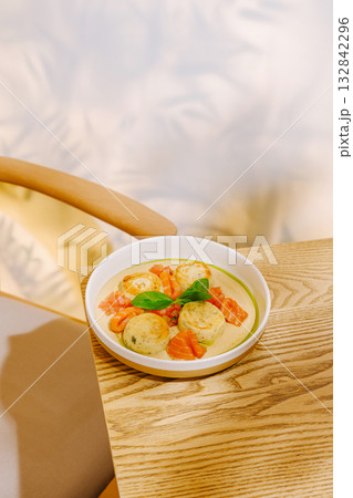 Delicious plate of salmon with creamy sauce served on a wooden table 132842296