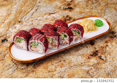 Delicious sushi rolls served on a white plate with condiments Delicious sushi rolls served on a white plate with condiments 132842352