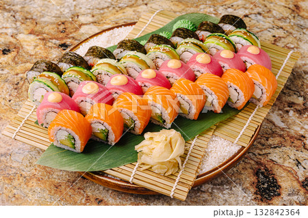 Sushi platter featuring assorted rolls presented on a decorative tray 132842364