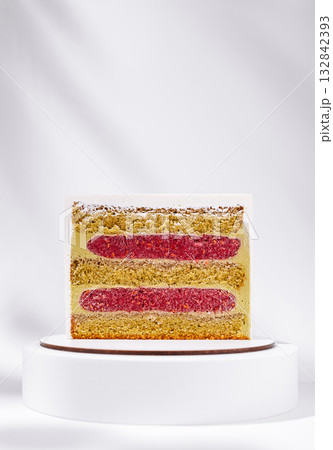 Delicious layered cake with pink filling on a white stand Delicious layered cake with pink filling on a white stand 132842393