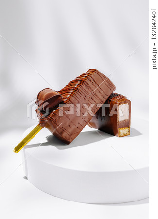 Delicious chocolate popsicle and cut piece on a white display 132842401
