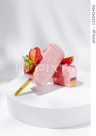 Delicious strawberry ice cream pops on a white platform in bright light 132842402