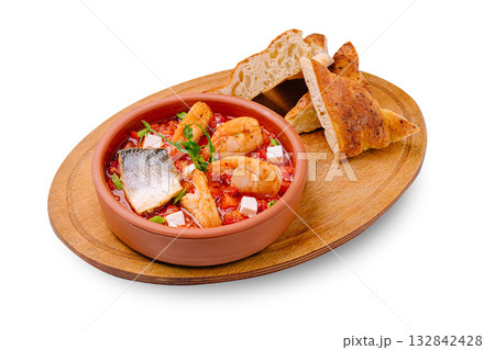 Delicious seafood stew served with fresh bread on a wooden platter Delicious seafood stew served with fresh bread on a wooden platter 132842428