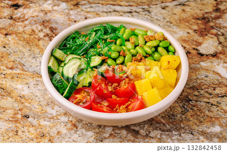 Fresh vegetable bowl with vibrant greens and fruits for healthy eating Fresh vegetable bowl with vibrant greens and fruits for healthy eating 132842458