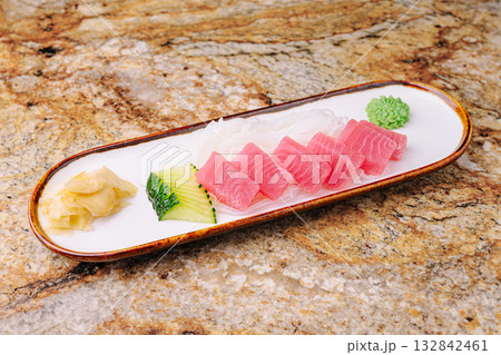 Sashimi platter with tuna and garnishes in a Japanese restaurant 132842461