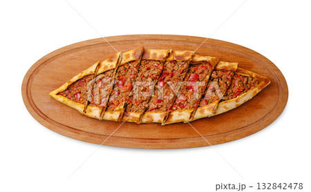 Delicious pide served on a wooden board in a traditional Turkish setting Delicious pide served on a wooden board in a traditional Turkish setting 132842478