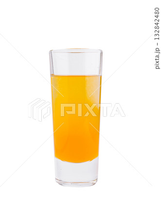 Bright orange drink in a tall glass on a clean white background Bright orange drink in a tall glass on a clean white background 132842480