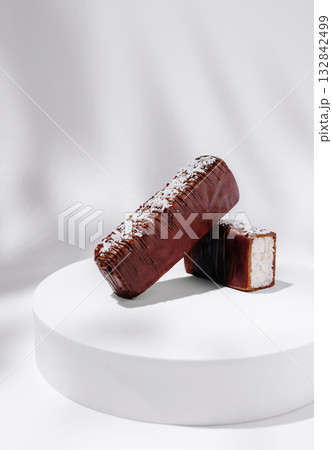 Delicious chocolate-covered treats on a white pedestal showcase 132842499