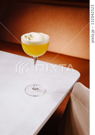 Refreshing cocktail served in an elegant glass on a wooden table Refreshing cocktail served in an elegant glass on a wooden table 132842523