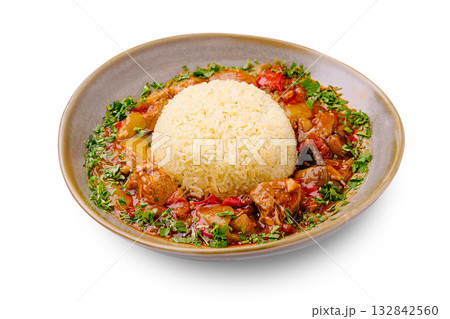 Delicious bowl of chicken stew served with rice and fresh herbs on a plate Delicious bowl of chicken stew served with rice and fresh herbs on a plate 132842560