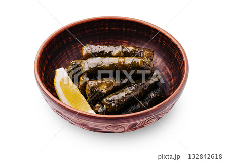 Delicious dolma served with lemon wedges in a rustic bowl Delicious dolma served with lemon wedges in a rustic bowl 132842618