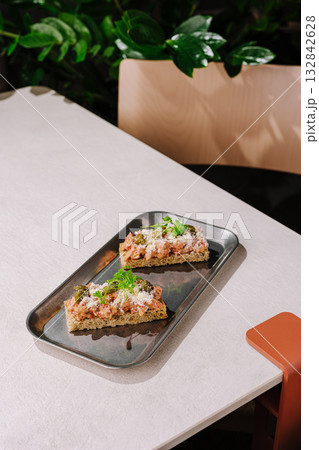 Delicious open-faced sandwiches served on a tray in a cozy cafe setting Delicious open-faced sandwiches served on a tray in a cozy cafe setting 132842628