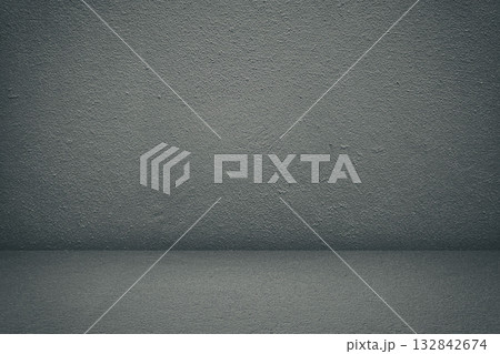 Empty room with dark textured concrete wall and floor. 132842674