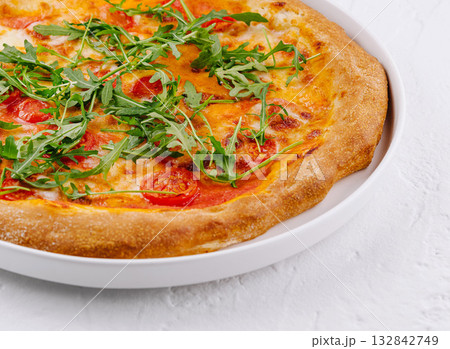 Fresh italian pizza with arugula and tomato Fresh italian pizza with arugula and tomato 132842749