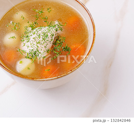 Homemade vegetable soup with carrots and herbs in a bowl Homemade vegetable soup with carrots and herbs in a bowl 132842846