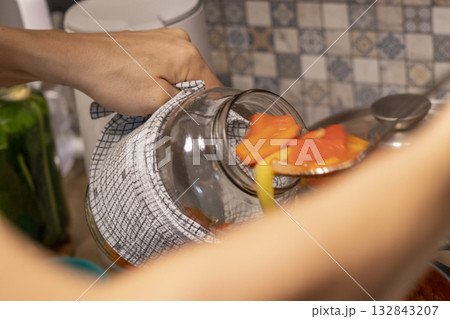 Person pouring hot boiled ed capsicums, cut in large slices Person pouring hot boiled ed capsicums, cut in large slices 132843207