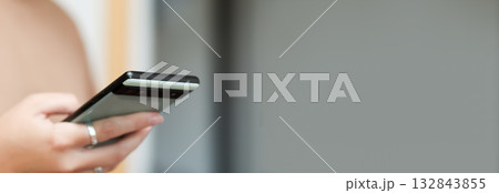 A person is intensely scrolling on a smart phone. feed of bad media news. The banner is designed with clear copy space. smart phone scrolling anxiety banner copy space 132843855