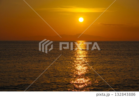 兵庫県南あわじ市　慶野松原海水浴場から小豆島に沈む夕陽を望む 132843886