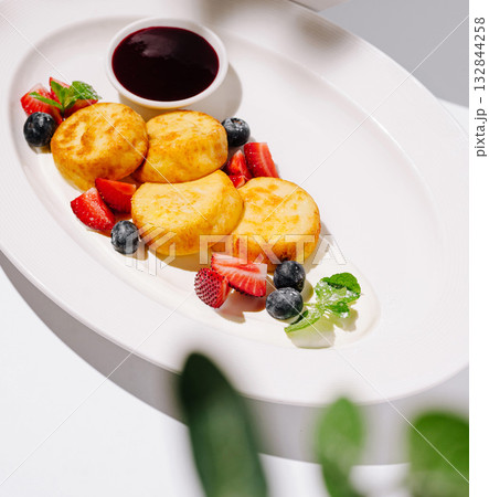 Delicious breakfast dish featuring cheese pancakes and fresh berries 132844258