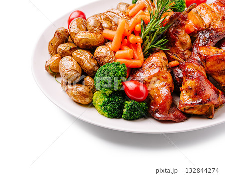 Grilled chicken with roasted potatoes and mixed vegetables served on a plate Grilled chicken with roasted potatoes and mixed vegetables served on a plate 132844274