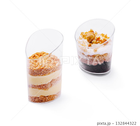 Desserts served in clear cups with layers of cream and toppings Desserts served in clear cups with layers of cream and toppings 132844322