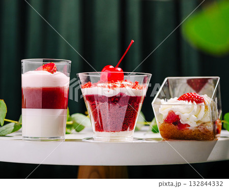 Delicious layered desserts displayed on a table showcasing vibrant colors Delicious layered desserts displayed on a table showcasing vibrant colors 132844332