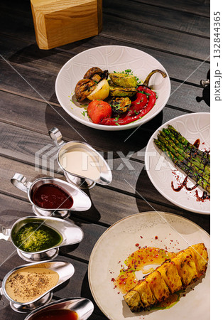 Enjoy grilled veggies and sauces at a modern dining spot Enjoy grilled veggies and sauces at a modern dining spot 132844365