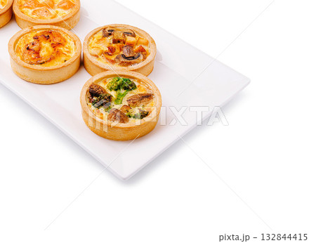 Delicious savory tarts served on a white plate for a tasty snack Delicious savory tarts served on a white plate for a tasty snack 132844415
