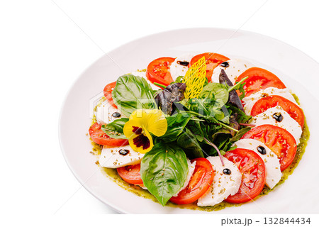 Fresh mozzarella and tomato salad with basil and herb pesto drizzle 132844434